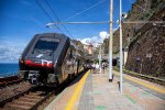 A Hitachi "Rock" EMU departs Manarola for points South 